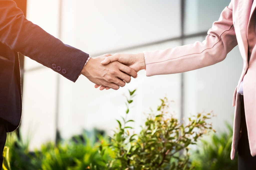closeup friendly meeting handshake between business woman and b